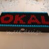 Logotipo de Okal en moras rojas azules y negras